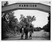 Students standing underneath Harbison sign.