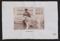 Alaska Native man with dog.