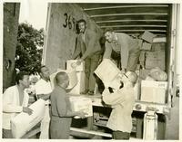 Group of men loading a truck.