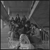 Girls sitting on stairs.