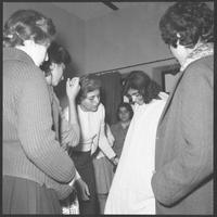 Teacher and students examining a costume.