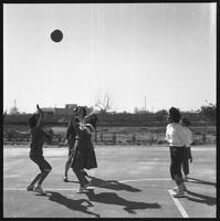 Students playing basketball.