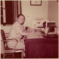 Edith Millican working at her desk.