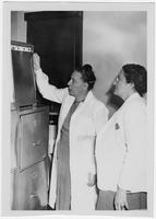 Edith Millican and another doctor examining an x-ray.