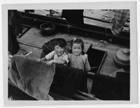 Two children on a boat.