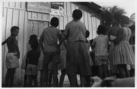 Kids looking at poster for ABC Literary Crusade, Recife, Brazil, ca. 1966.