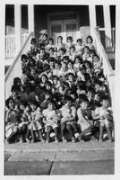 Group of girls seated on steps.