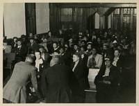 A crowd of men and women seated.