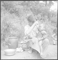 A woman feeding a baby in Andong, 1954.