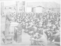 Rev. Earle Woodberry holding a service for prisoners of war, 1954.