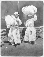Two women carrying heavy loads in Chaeryŏng, Korea.