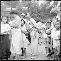 Korean women and children in line for supplies.