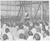 Rev. Harold Voelkel preaching to Korean prisoners of war, ca. 1950.