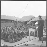 A Bible Institute boy leads a country congregation in Sunday worship, Taegu, ca. 1955.