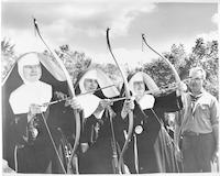 Nuns practice bow and arrow.