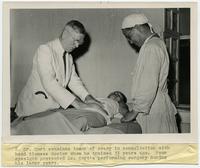 Dr. Edwin Charles Cort consults a patient.