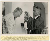 Dr. Edwin Charles Cort receives lei.
