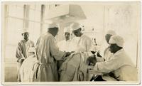 Dr. Nelson Bell operating on a patient, Tsingkiangpu, China.