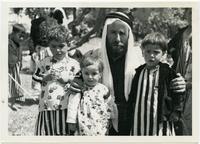 Qawwal Hasan and his children in the garden of Sheikh Bekr Tawaafi, 1957.