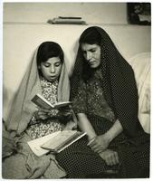 Woman and child reading together, Iran, circa 1960.
