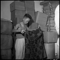 Chinese refugee sorting supplies.