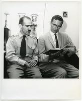 Iranian army officer reads hymnal with the Rev. Durwood A. Busse, circa 1960.