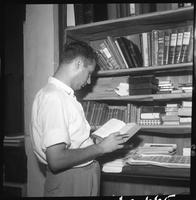 Man looking at Bible in bookstore, Beirut, Lebanon, 1960.