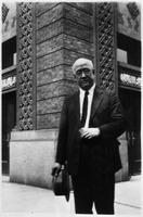 Unidentified man in front of a building, China.