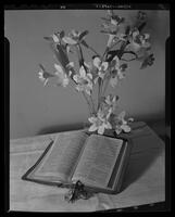 Bible open with flowers.