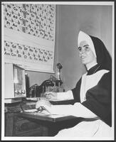 Nun studies at nuclear institute.