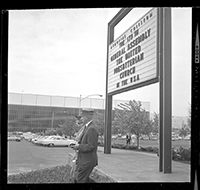 Memorial Coliseum signage with passersby.