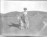 Mary A. Zoeckler riding on a donkey.