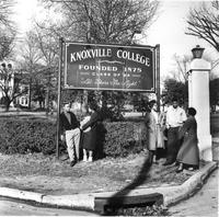Students by Knoxville College sign.
