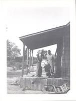 Man and woman on porch with basket.