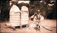 Mukete man with peanut crop in baskets.