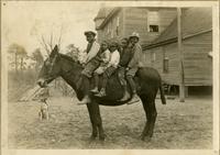 Five students riding a horse at the Emerson Institute, Blackville, South Carolina.