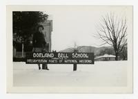 Student standing in front of Dorland Bell School sign.